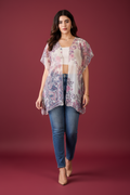 Woman wearing a floral kimono-style top on a white background