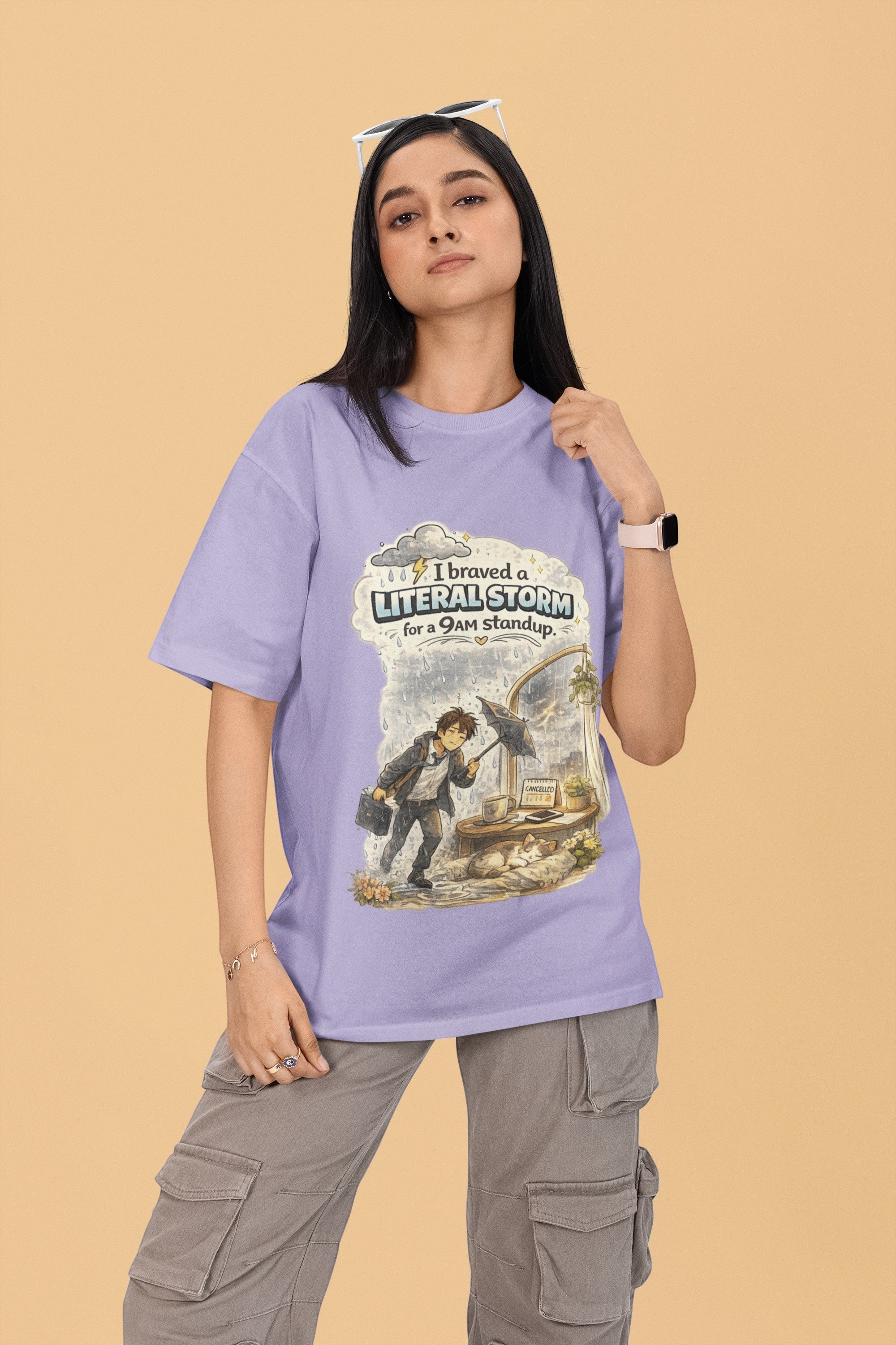 Snuggle Spot lavender oversized terry-knit t-shirt with graphic print, worn by a woman with grey cargo pants.