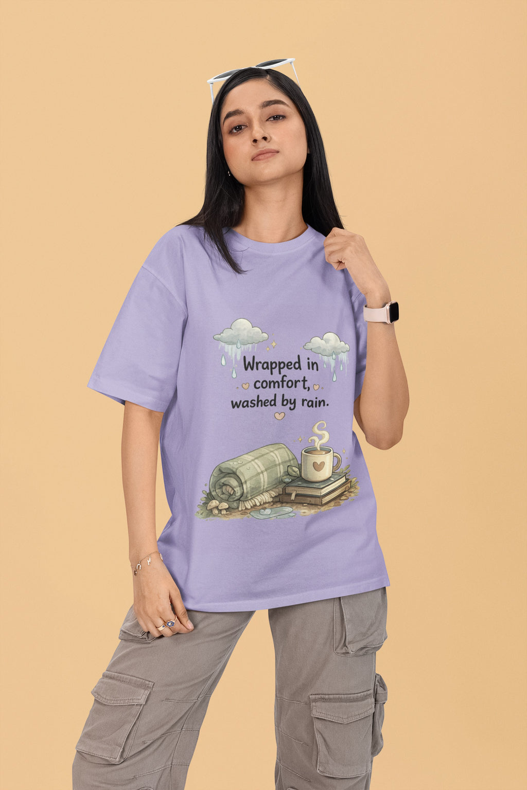 Model wearing a Snuggle Spot lavender oversized terry-knit t-shirt with a cozy rain-themed graphic print.