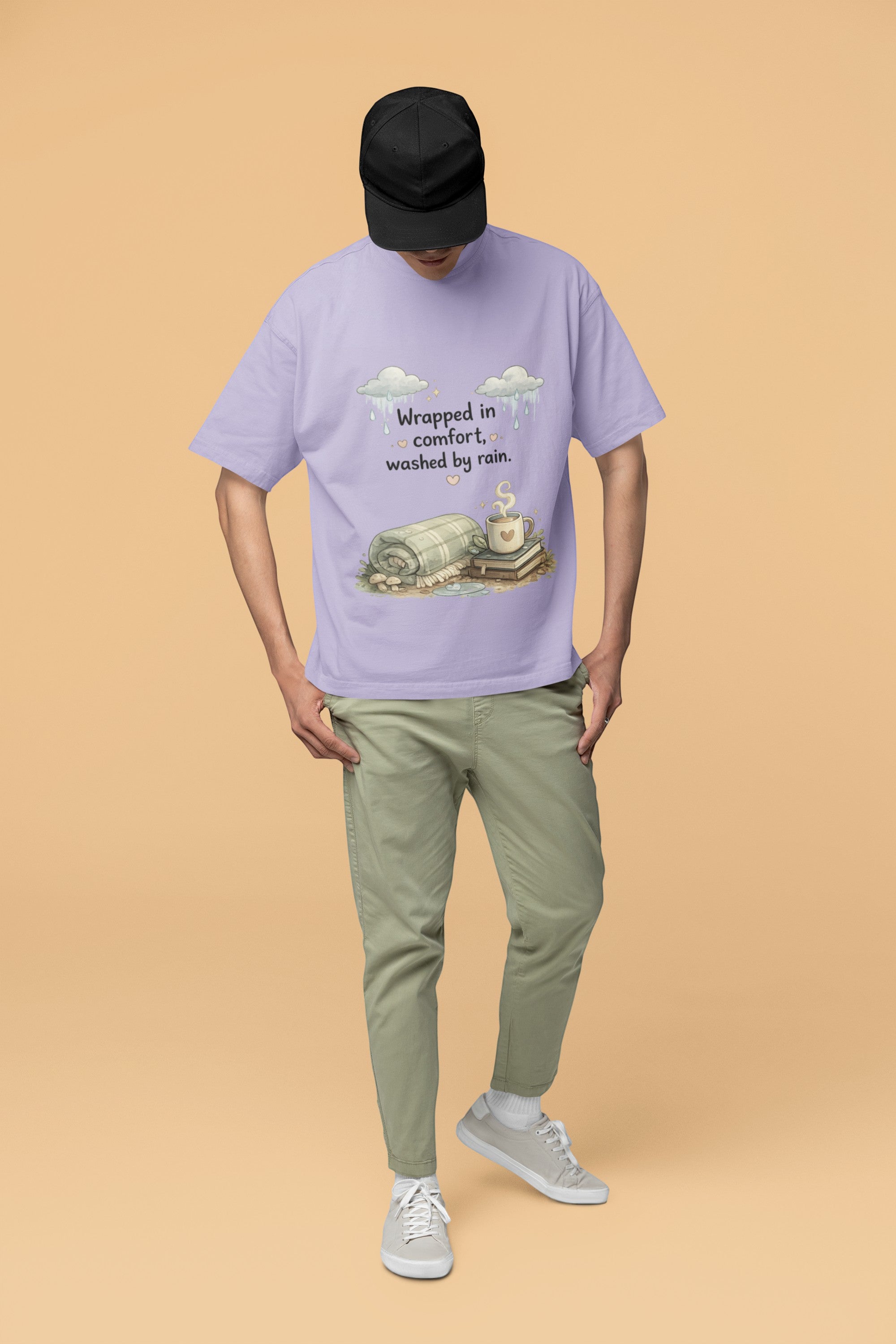 Snuggle Spot lavender oversized terry-knit t-shirt with Wrapped in Comfort graphic, worn by a man in a black cap.