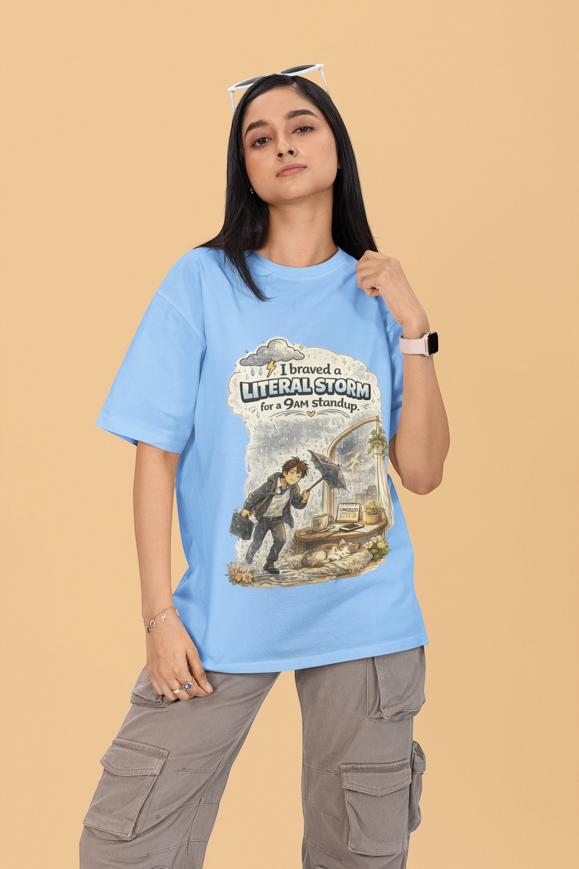 Snuggle Spot unisex oversized light blue t-shirt with graphic print, worn by a woman with grey cargo pants.
