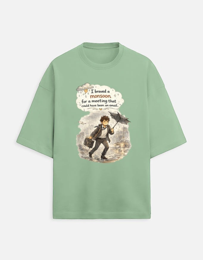 Snuggle Spot sage green oversized unisex t-shirt with a graphic of a man in rain with text about office meetings.
