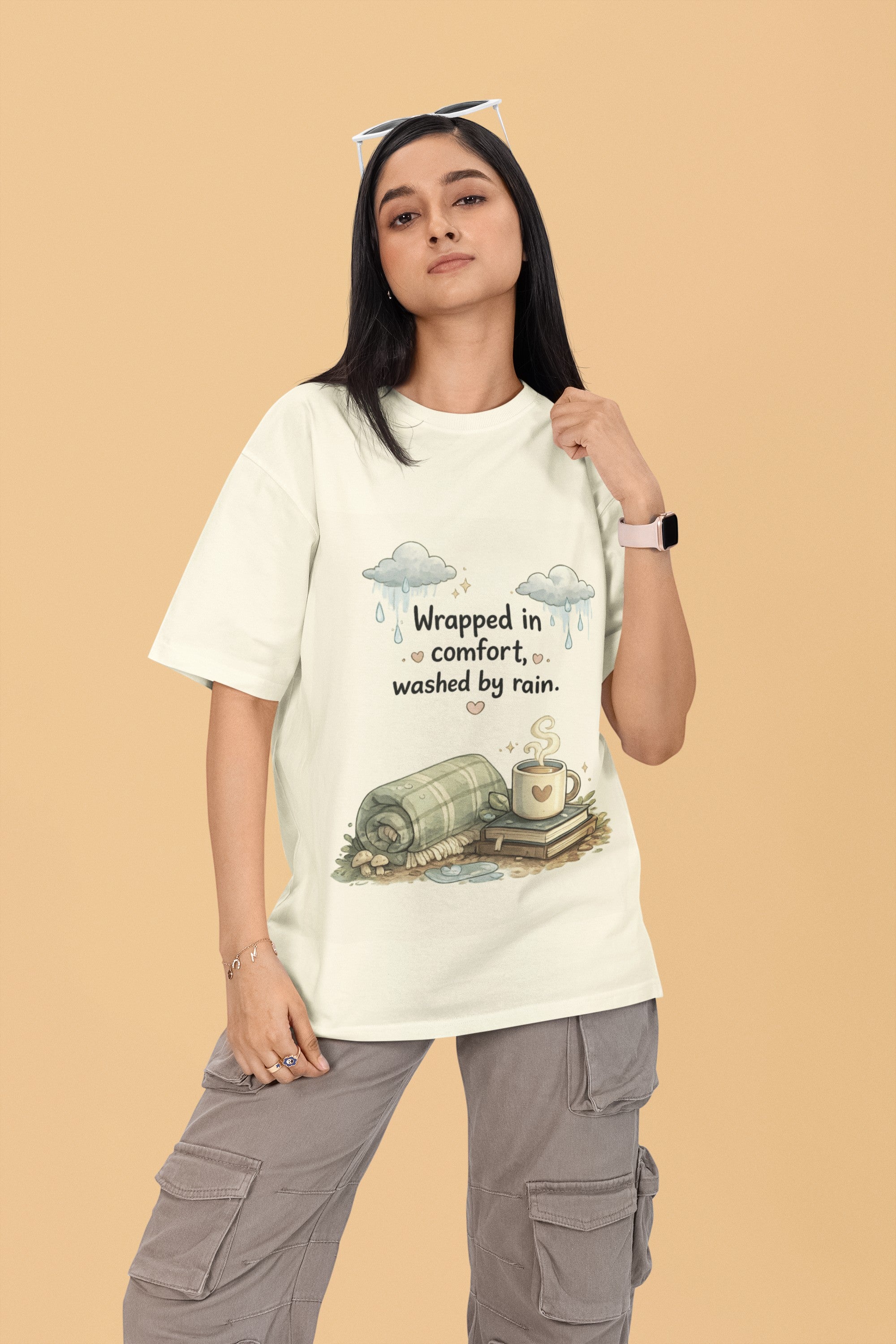 Model wearing a Snuggle Spot cream oversized terry t-shirt with a cozy rain-themed graphic print.