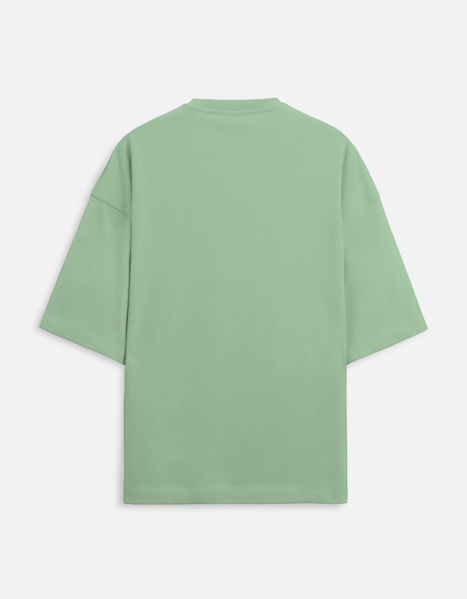 Snuggle Spot unisex oversized terry-knit t-shirt in a light sage green with drop shoulders and a structured fit.