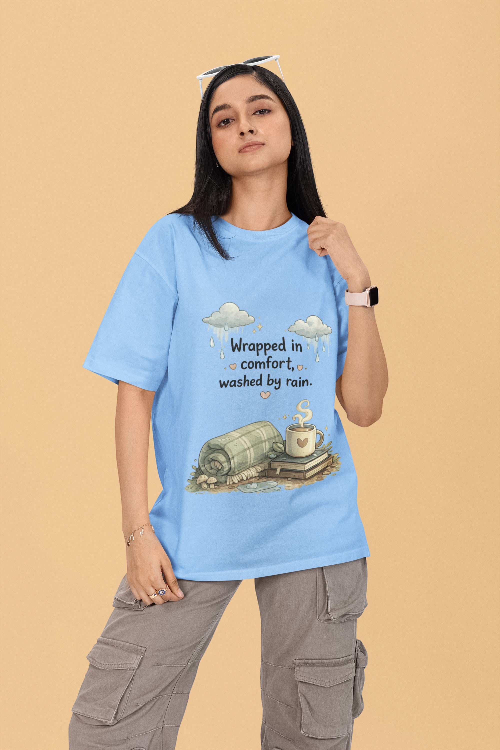 Snuggle Spot light blue oversized terry-knit t-shirt with rain and coffee graphic on a woman wearing cargo pants.
