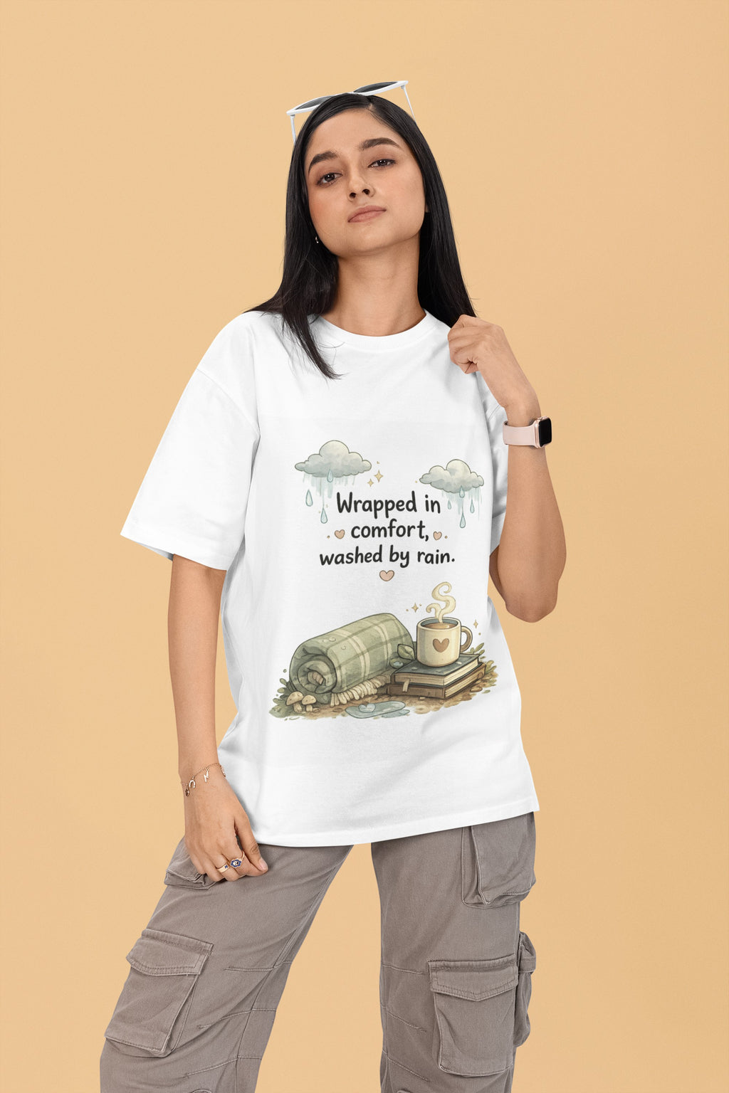 Model wearing a white Snuggle Spot oversized terry-knit t-shirt with a cozy rain-themed graphic print.