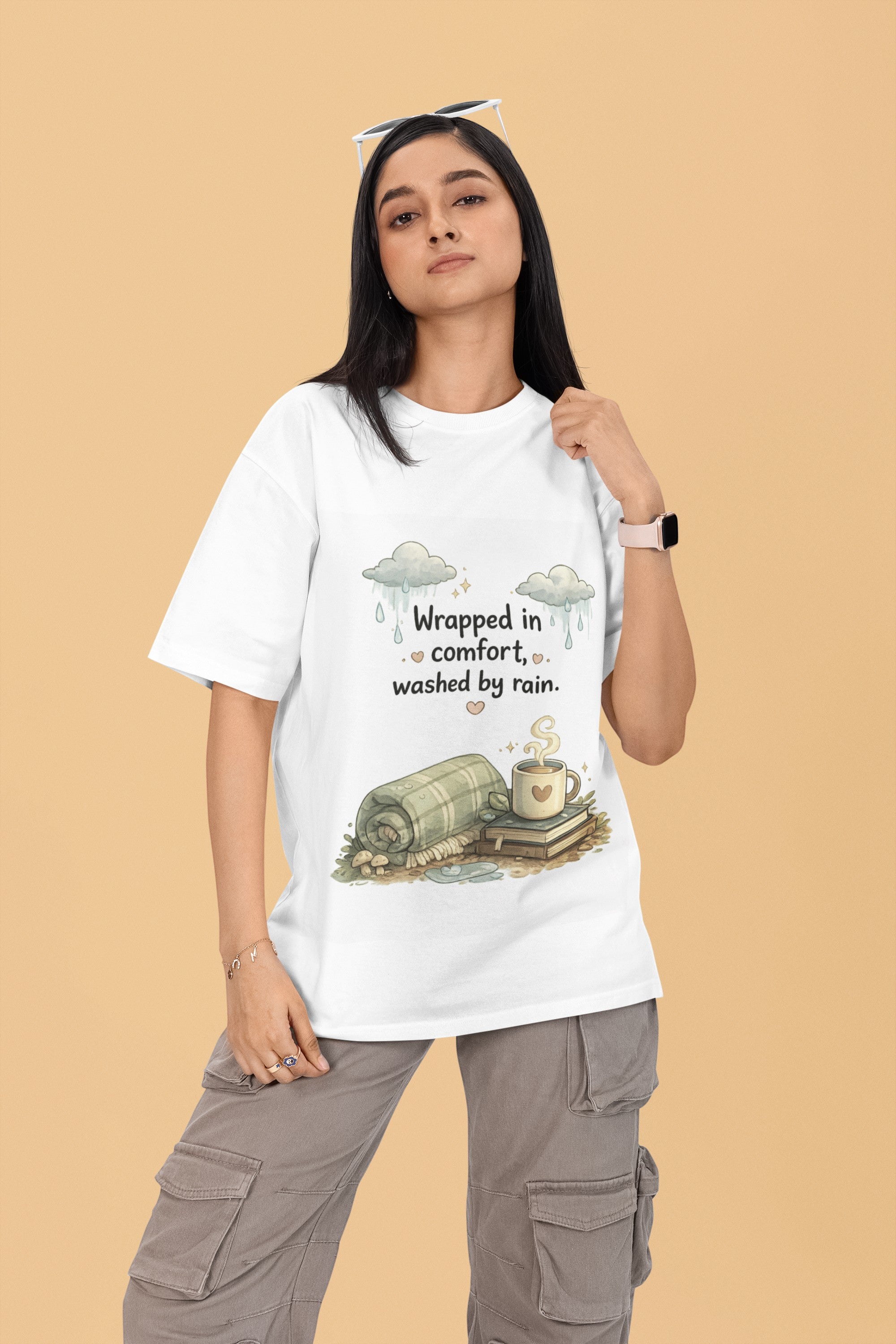 Model wearing a white Snuggle Spot oversized terry-knit t-shirt with a cozy rain-themed graphic print.