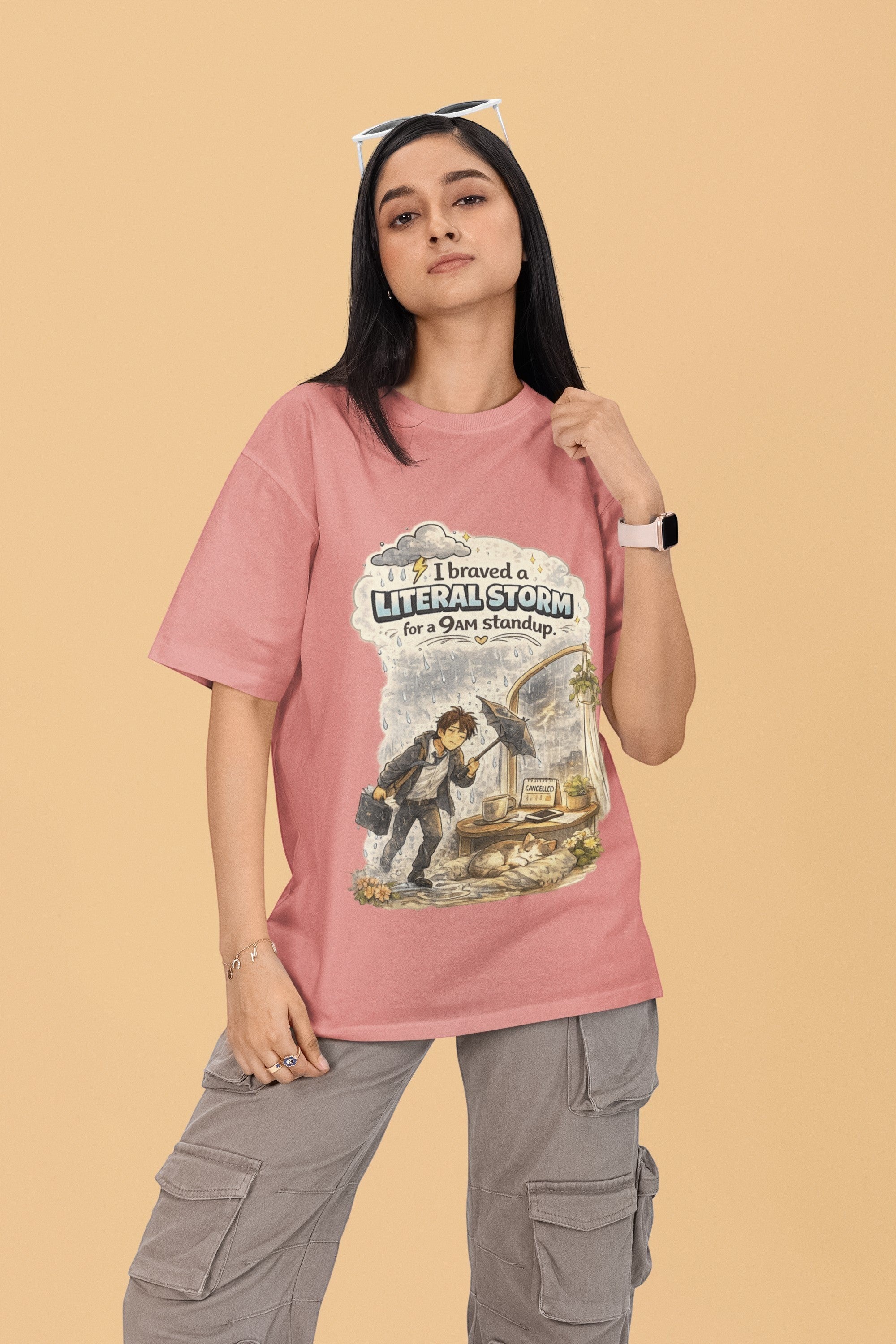 Model wearing a pink Snuggle Spot oversized terry-knit t-shirt with a graphic print about braving a storm for work.