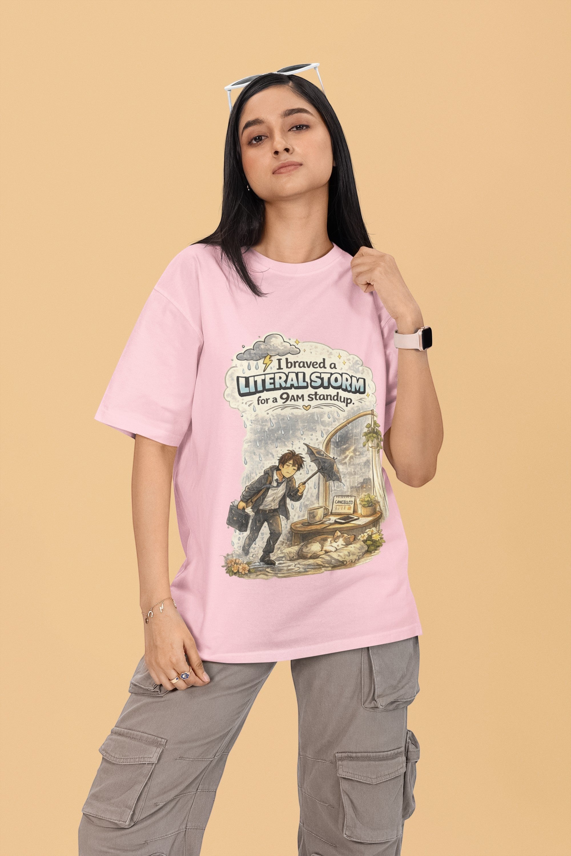 Model wearing a pink Snuggle Spot oversized terry-knit t-shirt with a graphic print about braving a storm for work.