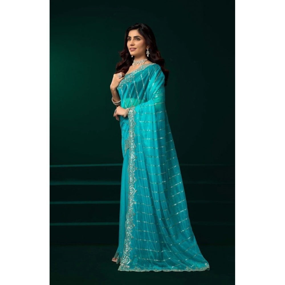 Snuggle Spot turquoise net sequence saree with unstitched blouse, featuring a delicate sequin pattern and embellished border.