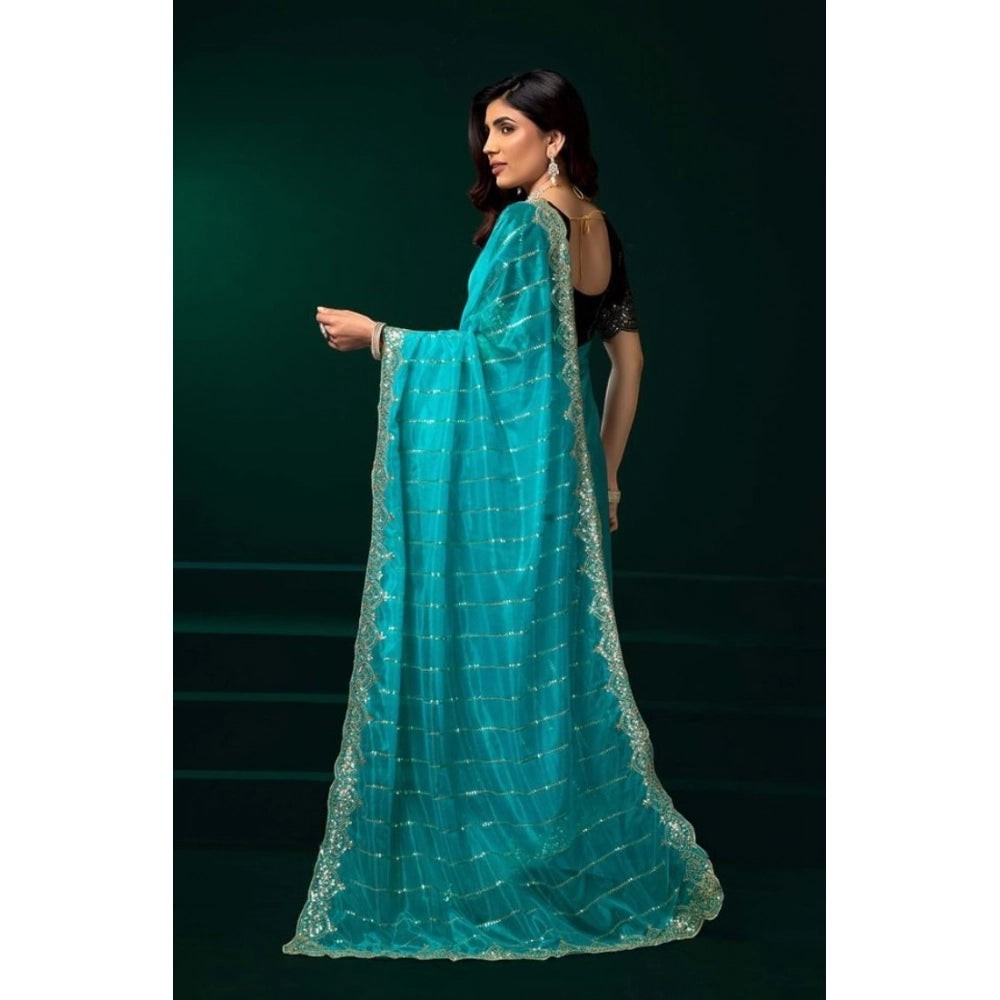 Snuggle Spot turquoise net sequence saree with unstitched blouse, featuring a scalloped sequined border.